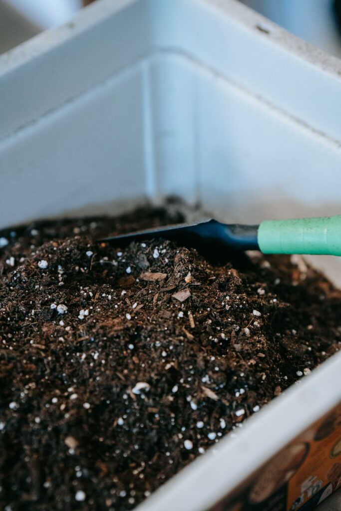 Healthy compost in a bucket with a small shovel